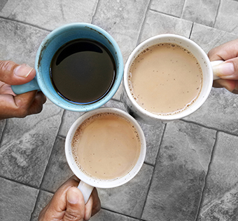 Hands holding coffee cups